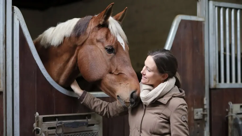 Frau mit Pferd im Stall